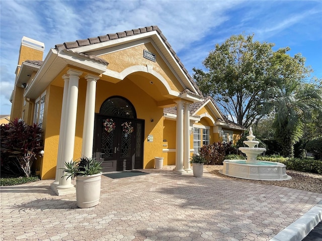 view of exterior entry featuring french doors