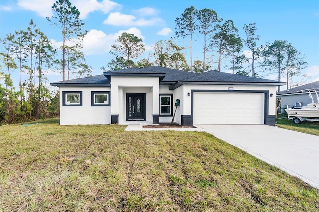 view of front of property with a front yard and a garage