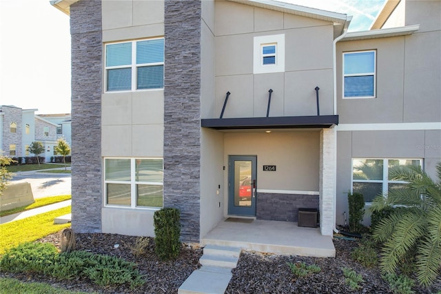 1264 Challenge Dr, Davenport, FL 33896 - doorway to property with stone siding and stucco siding