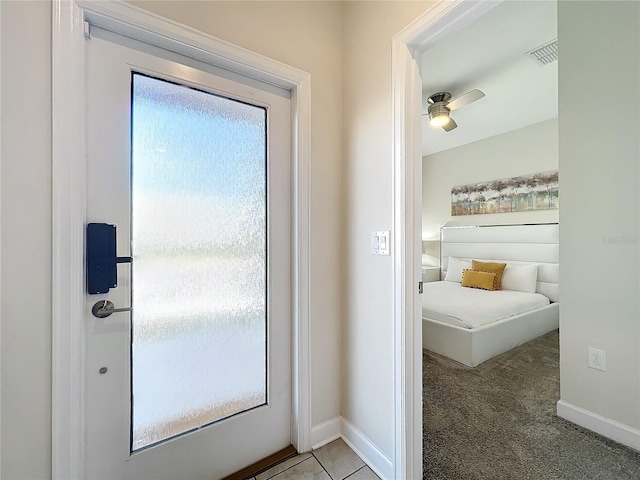 doorway to outside with ceiling fan, a healthy amount of sunlight, and light carpet