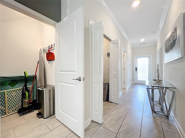 hall featuring crown molding and light tile patterned floors