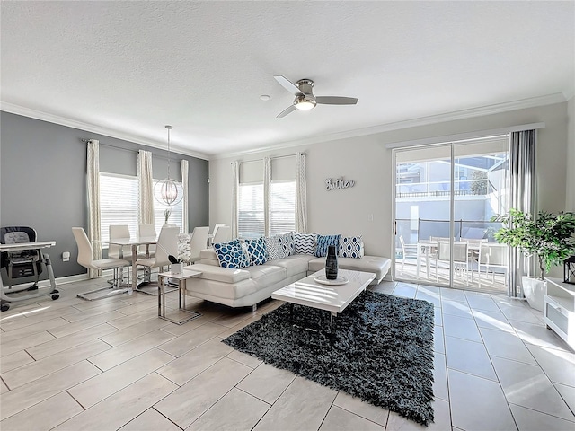 tiled living room with plenty of natural light, ceiling fan with notable chandelier, a textured ceiling, and ornamental molding