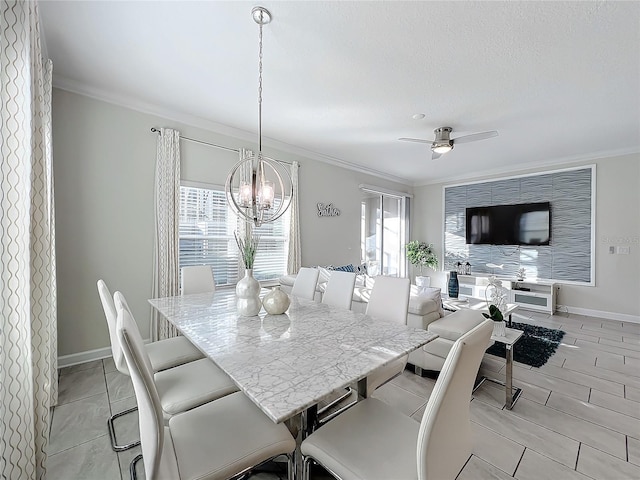 dining space featuring crown molding and ceiling fan with notable chandelier