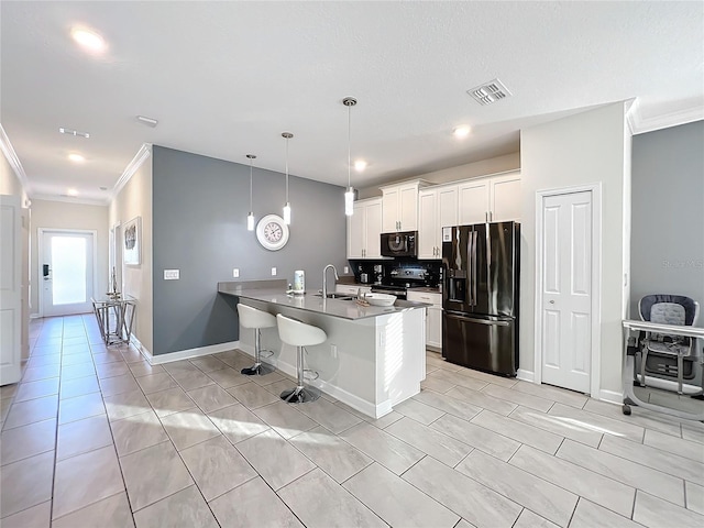 kitchen with white cabinetry, black appliances, decorative light fixtures, and ornamental molding