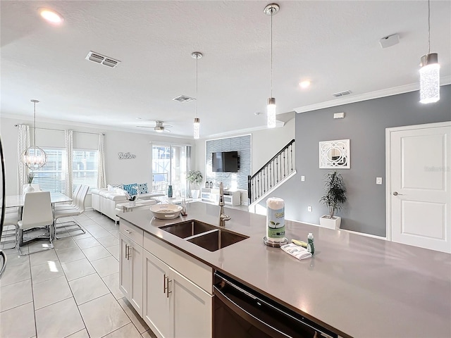 kitchen with white cabinets, decorative light fixtures, crown molding, and sink