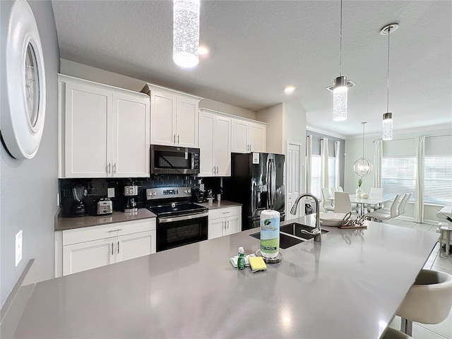 1264 Challenge Dr, Davenport, FL 33896 - kitchen with stainless steel electric range, black refrigerator with ice dispenser, a sink, a kitchen bar, and tasteful backsplash