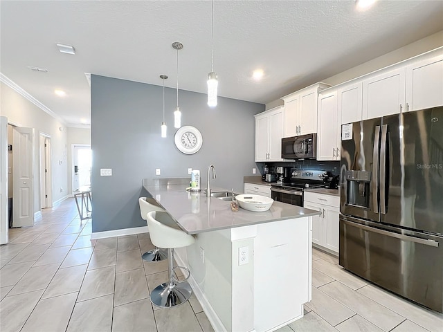 kitchen featuring sink, stainless steel appliances, crown molding, decorative light fixtures, and white cabinets