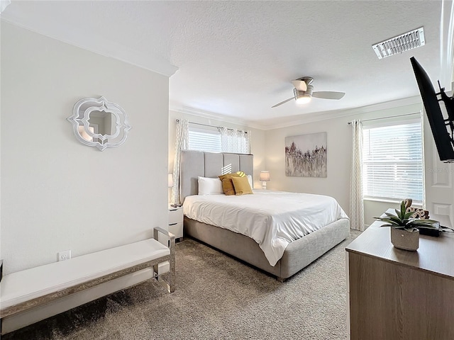 bedroom with carpet flooring, multiple windows, ceiling fan, and ornamental molding