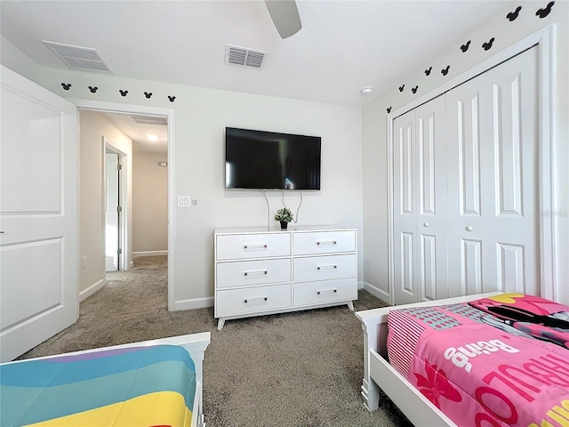 bedroom featuring ceiling fan, a closet, and dark colored carpet