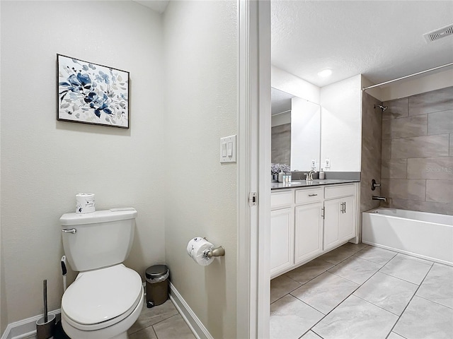 full bathroom with tile patterned floors, vanity, a textured ceiling, tiled shower / bath combo, and toilet