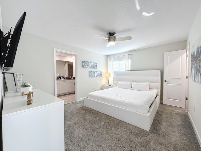 1264 Challenge Dr, Davenport, FL 33896 - bedroom featuring light carpet, baseboards, connected bathroom, and a ceiling fan