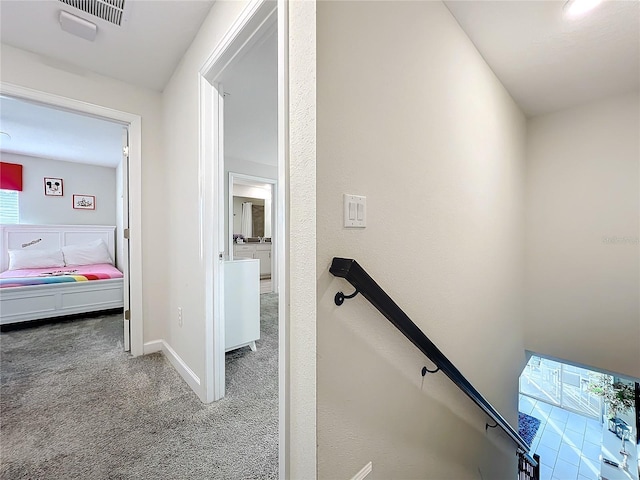 staircase with carpet floors and a healthy amount of sunlight