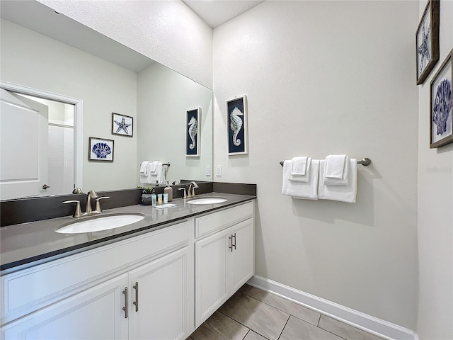 1264 Challenge Dr, Davenport, FL 33896 - bathroom featuring double vanity, baseboards, and tile patterned flooring