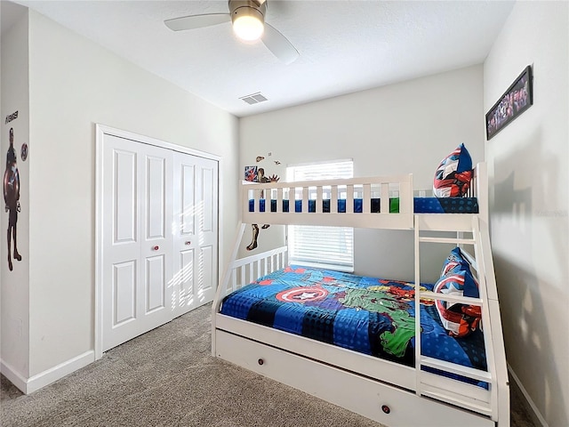 carpeted bedroom featuring ceiling fan and a closet