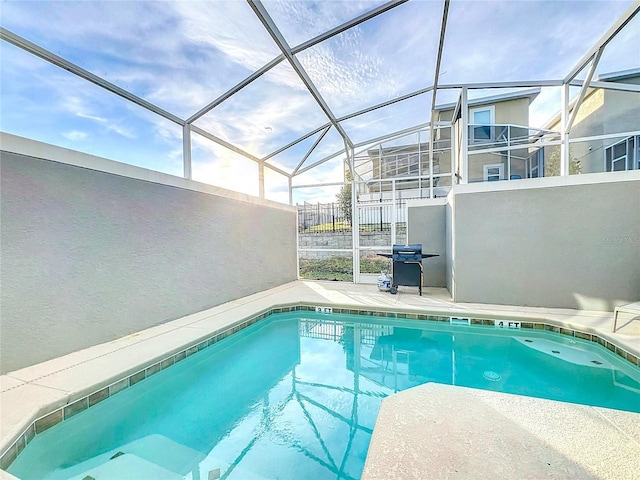 1264 Challenge Dr, Davenport, FL 33896 - outdoor pool with glass enclosure and a patio area