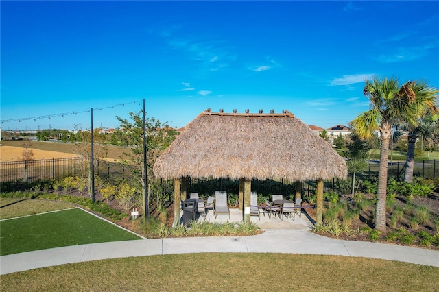 view of property's community featuring a gazebo, a lawn, and a patio