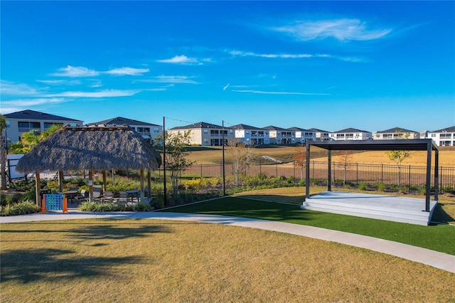 surrounding community with a gazebo and a yard