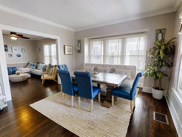 dining space featuring crown molding, ceiling fan, and dark wood-type flooring