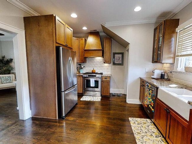 kitchen with ornamental molding, stainless steel appliances, dark hardwood / wood-style floors, and custom exhaust hood