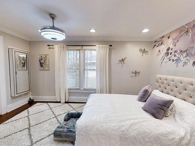 bedroom with hardwood / wood-style floors and ornamental molding