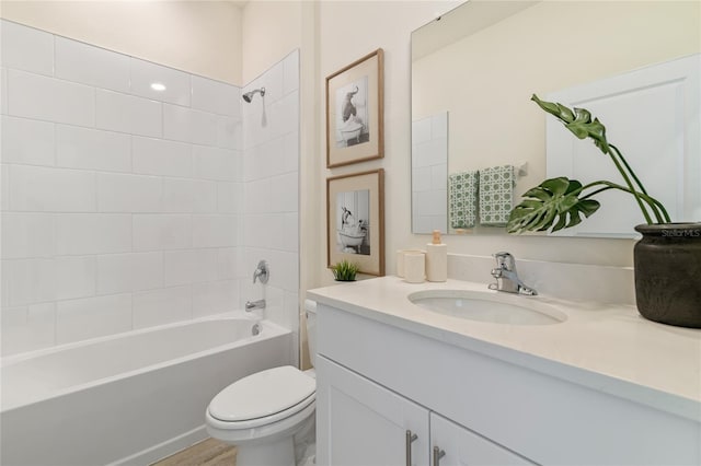 full bathroom featuring vanity, toilet, and tiled shower / bath combo