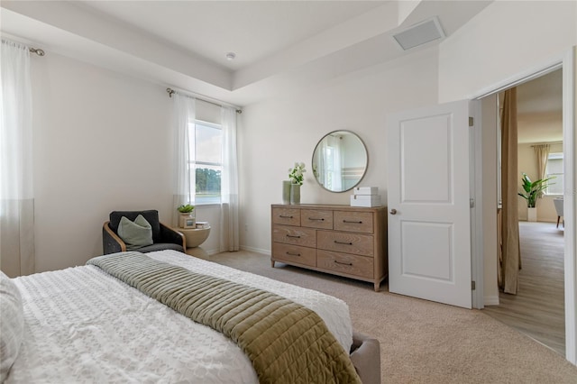 bedroom featuring light carpet