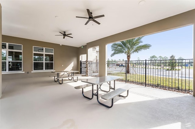 view of patio with ceiling fan and a water view