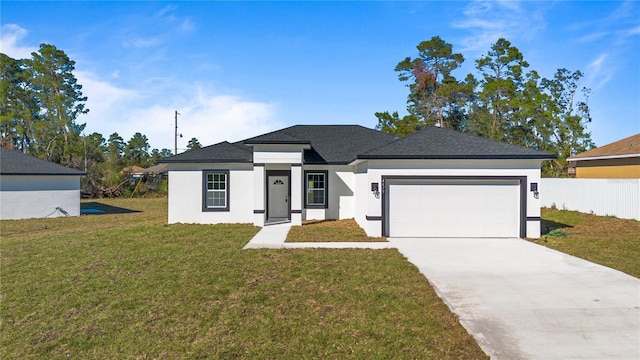 view of front of house featuring a garage and a front yard