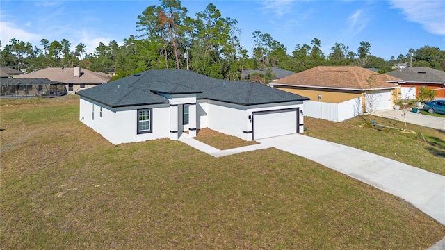 view of front of property with a garage and a front lawn