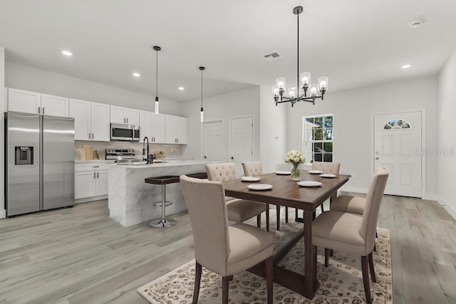 4479 SW 170th Rd, Ocala, FL 34473 - dining area with recessed lighting, light wood-style flooring, visible vents, and an inviting chandelier