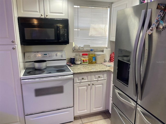 kitchen featuring light stone countertops, light tile patterned floors, white electric range, stainless steel fridge with ice dispenser, and white cabinets