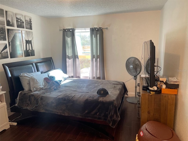 bedroom with hardwood / wood-style floors and a textured ceiling