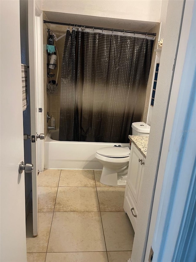 full bathroom featuring tile patterned floors, vanity, shower / bath combination with curtain, and toilet