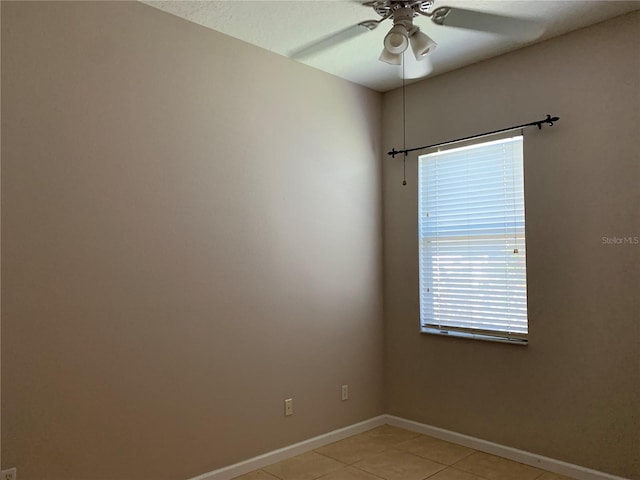 unfurnished room with ceiling fan and light tile patterned floors