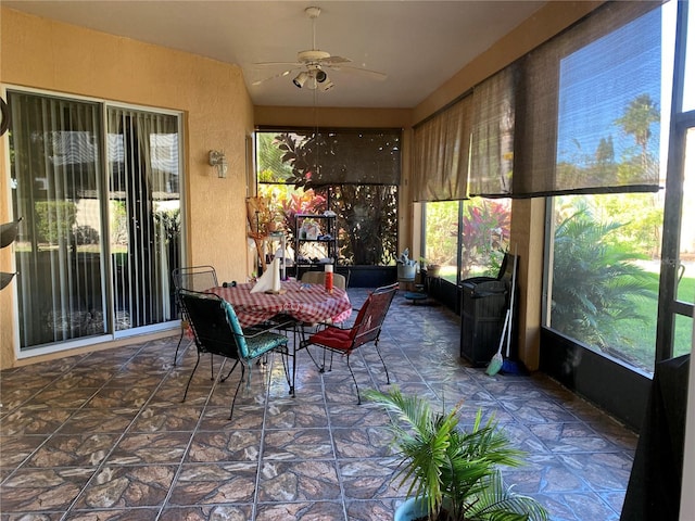 sunroom / solarium featuring plenty of natural light and ceiling fan