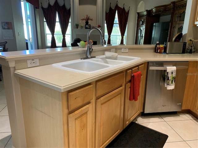 kitchen with sink, light tile patterned floors, and stainless steel dishwasher