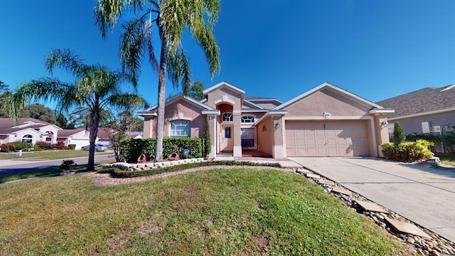 ranch-style house featuring a garage and a front lawn