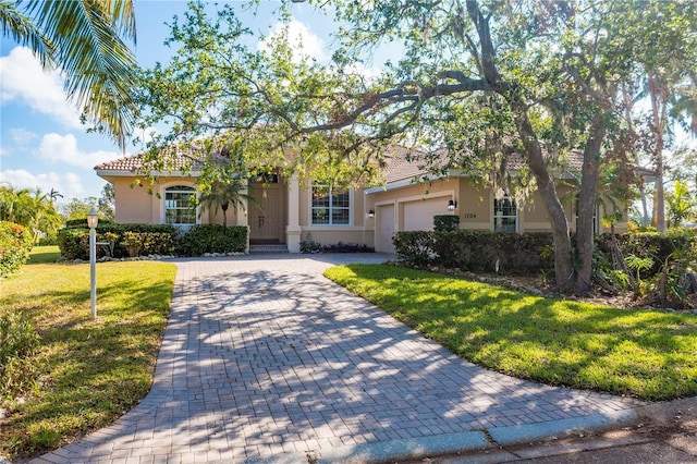 view of front facade with a front yard and a garage