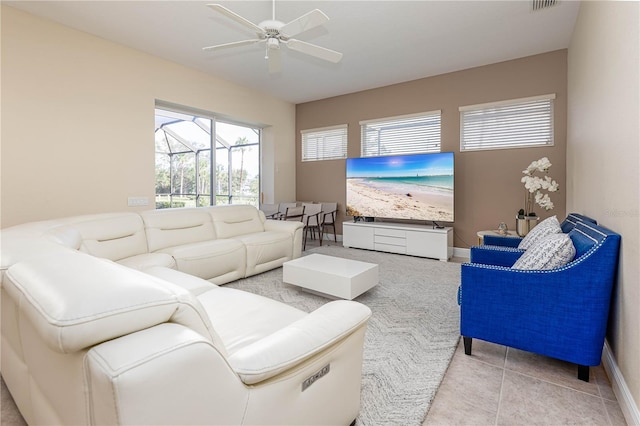 living room with ceiling fan and light tile patterned flooring