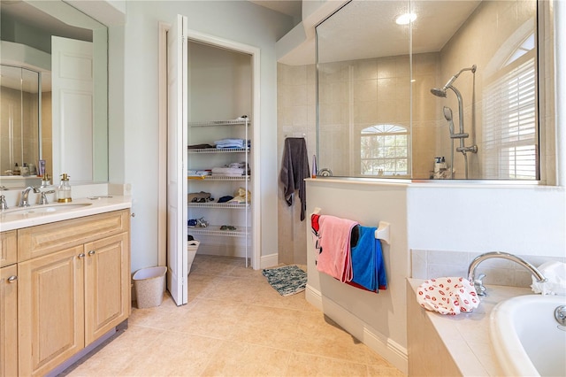 bathroom featuring tile patterned flooring, vanity, and independent shower and bath