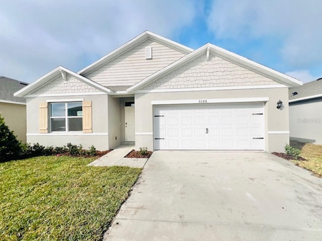 view of front of property featuring a garage and a front yard