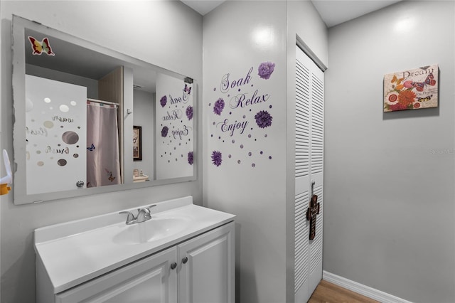 bathroom with vanity and wood-type flooring