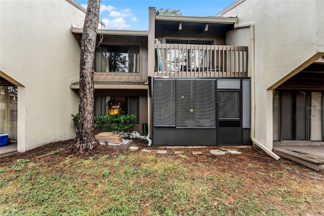 back of property with a balcony