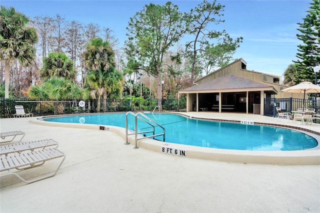 view of swimming pool with a patio area