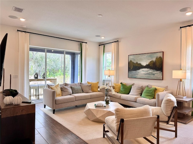 living room featuring a textured ceiling and dark hardwood / wood-style flooring