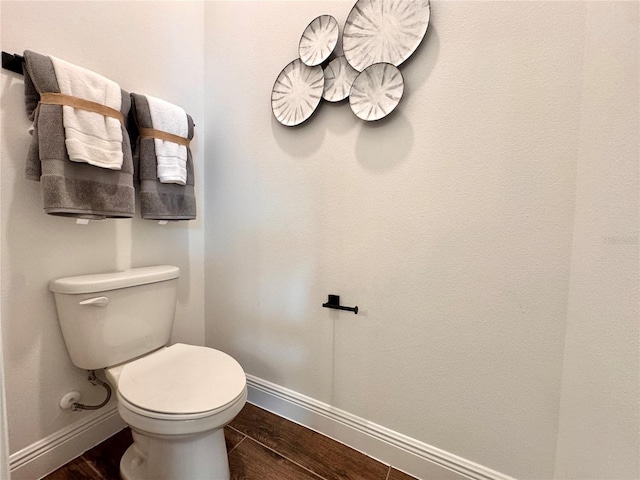 bathroom with hardwood / wood-style flooring and toilet