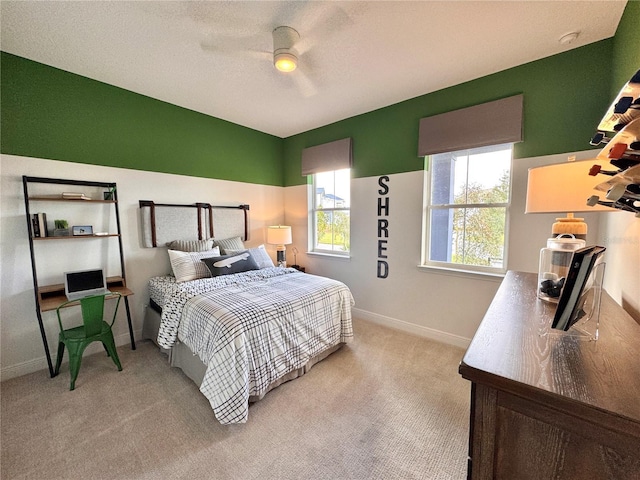 bedroom featuring ceiling fan and light carpet