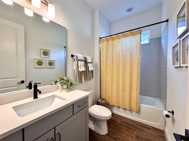 full bathroom with hardwood / wood-style floors, vanity, toilet, and shower / bath combo with shower curtain