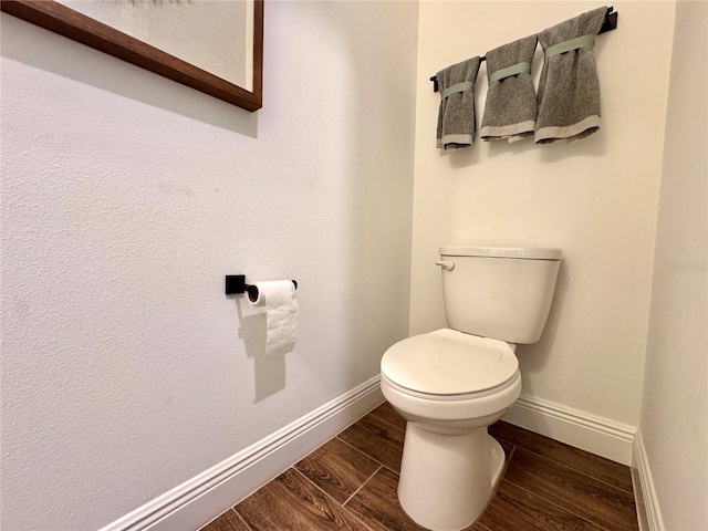 bathroom featuring hardwood / wood-style flooring and toilet