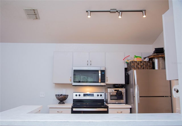 kitchen featuring white cabinetry and appliances with stainless steel finishes